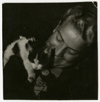 Rozka Grossman plays with a cat that she hid in her apartment in the Lodz ghetto.