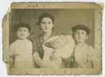 Ilona (Toba) Seidenfeld poses for a family portrait with her sons Ezra (left), Mordche (right), and Mojsche.