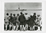 Children aboard the President Harding look at the Statue of Liberty as they pull into New York harbor.