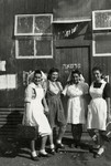 Four nurses stand outside a health clinic in a detention camp in Cyprus.