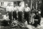 Chaim Leichter (kneeling, left) poses with other workers at a workshop where he is studying carpentry.
