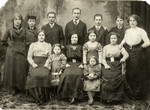 Studio portrait of Szajfman family.

Among those pictured are Tsvetle (Chaim Leichter's mother, standing far right) and Benjamin Szajfman (father of Sara), standing third from the right).