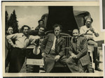 Members of the Bamberg Yiddish Theater group gather around a truck laden with props as they prepare to perform a play in a neighboring displaced persons camp.