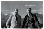Julien Bryan poses with another man in an unknown location [the Alps may be in the background].