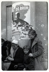 A Polish family huddles around a column in front of the Opera House in besieged Warsaw.