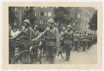 Dutch soldiers parade with their bicycles during the celebration of Queen Wilhelmina's 40th year on the throne.