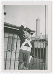Daniele Nacamu, dressed in the uniform of Figlio della Lupa, gives a Fascist salute on the terrace of his home in Bologna.