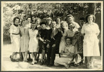 Group portrait of aid workers in what is [possibly the Nos Petits children's home].