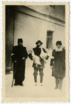 Portrait of three religious Jews, one holding a pair of geese, in the Krosno ghetto.