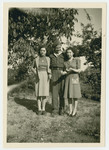 Three young adults pose in a garden in s Heerenberg after the war.