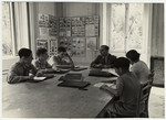 Older students study in a classroom decorated with photographs and posters in the Mediterranean School in Recco, Italy.