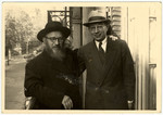 Rabbi Zalman Schneerson and Rabbi Kotujanski pose on a balcony in Paris after the war.