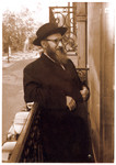 Rabbi Zalman Schneerson, leader of Orthodox Jewry in France, stands outside on a balcony.