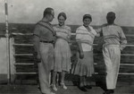 Refugees pose on the deck of a ship headed for Haita.