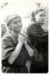 Close-up portrait of a praying Polish woman in besieged Warsaw.