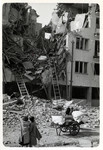 Two Polish women look at the destruction of an apartment building in besieged Warsaw.