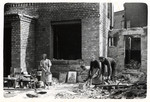 A Polish family picks up the pieces of the wreckage of a bombed out home in the besieged city of Warsaw.