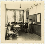 A boy writes Hebrew on the blackboard in a classroom of the Versoix children's home.