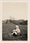 Minni Pickholz, a member of the Zionist youth movement, sits lin an open field probably in Elgg.