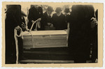 Freida Albin's coffin is lowered into her grave.