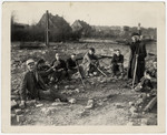 Survivors sit amidst the rubble of the Nordhausen concentration camp.