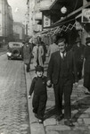 Reine walks down a street in Sofia hand in hand with her father Rachamin Behar.