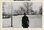 Karel Kasak, a Czech political prisoner in Dachau, stands outside in the snow outside the grounds of the camp.