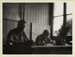 Czech political prisoners work in an office in the Dachau concentration camp.