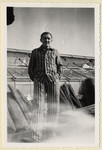 Portrait of Jiri Hell, a Czech political prisoner standing next to the greenhouses of the "Plantage" of the Dachau concentration camp.