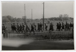 Clandestine photograph taken by Maria Seidenberger from the window of her family's home of German SS men and soldiers marching away from the Dachau concentration camp, the day before it was liberated.