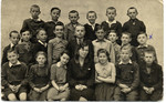 Group portrait of Polish students finishing the 6th grade and their teacher.
