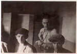 Survivors of the Hanover-Ahlem concentration camp pose inside of a barrack.