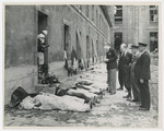 French Red Cross workers try to identify the bodies of French forces murdered outside the Chateau St.