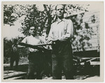Two former camp guards perform forced labor in the liberated Gusen concentration camp.