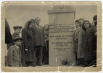 Survivors pose by the Bergen-Belsen memorial.

Standing on the left side: Man-wearing cap next to boy with cap is Mr.
