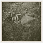 View of a desecrated Jewish grave.

The original caption reads "one of the many graves opened and looted for gold teeth etc."