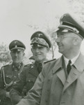 Reichsfuehrer SS Heinrich Himmler (right) shakes the hand of camp commandant Friedrich Warzok during an official tour of a Jewish labor camp along the main supply route in Galicia.
