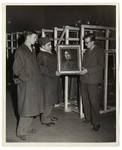 Examination of one of the framed paintings that was looted by the Nazi regime in an underground vault.
