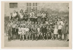 Group portrait of children standing outside of Chateau-le-Masgelier.