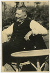 Moritz Gans sits in his garden.