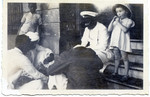 Joanna Klein watches a group of Indian men play cards while stopping in Bombay en route to America.