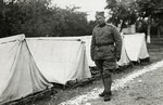 Moise Cassorla (father of the donor) poses in front of a row of tents, in an army uniform.