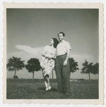 Ada and Rafael Abrahamer stand in a field in postwar Austria.