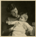 Edith Heller holds her baby daughter, Ruth in their home in Vienna.