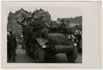 Residents of Pilsen, Czechoslovakia ride on an army truck in the parade celebrating the town's liberation.