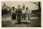 Group portrait of four Jewish orphans outside Home de la-Bas in Aische-en-Refail.