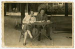 Bertha and Emil Forchheimer rest at an outdoor table while on their honeymoon.