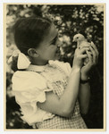 Zdenka Husserl holds a young bird, probably at Isleworth.