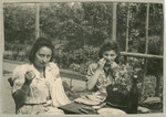 Hanna Bratman and her sister-in-law Hanka Bratman Fisch sit outside and sew in the Lampertheim displaced persons camp.
