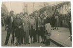 A group of Jewish young adults pose on a street in Warsaw.